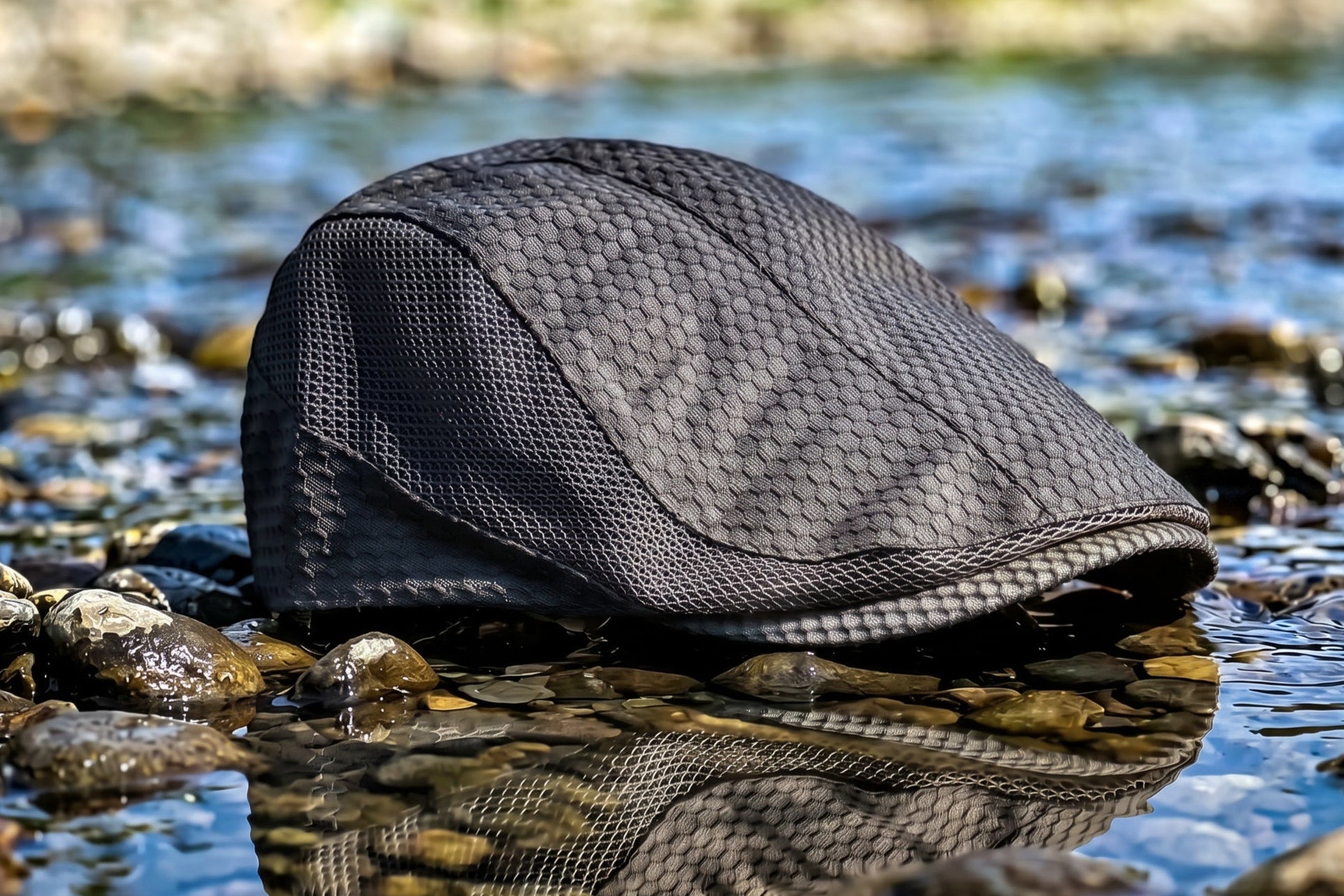 Black mesh bag on a rocky surface with water in the background