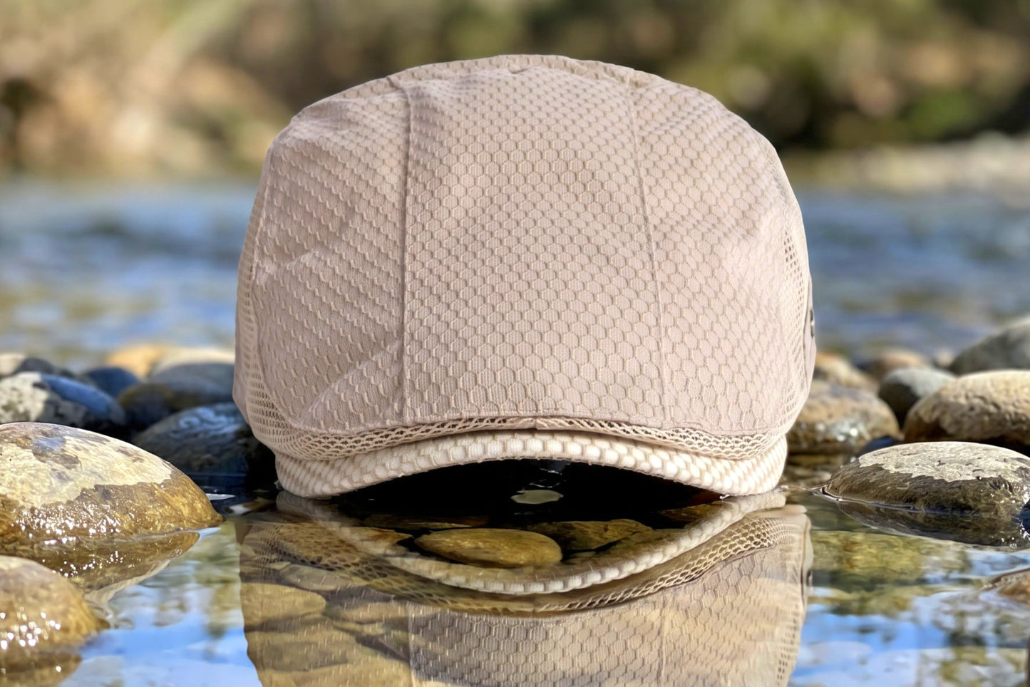 Beige cap on a rock with water and blurred natural background