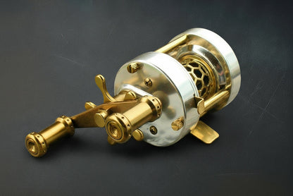 Brass fishing reel on a dark background
