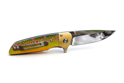 Folding knife with green handle featuring red and white patterns on a white background