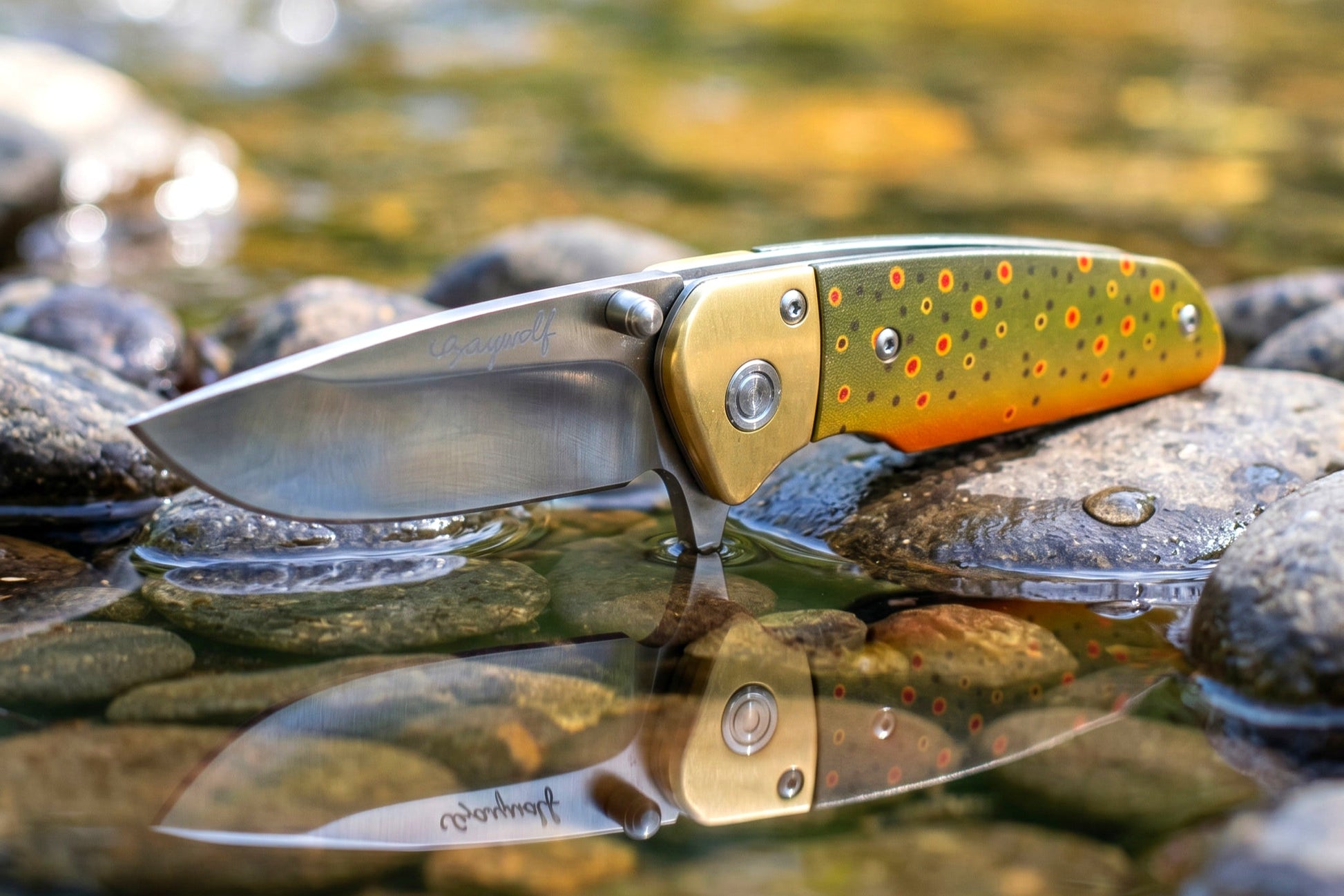 Folding knife with a decorative handle on a reflective water surface