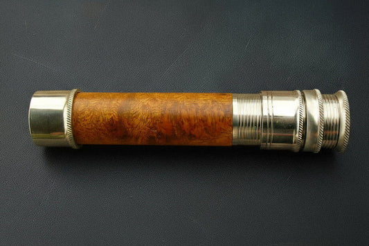 Vintage-style telescope with wooden and metal design on a dark background